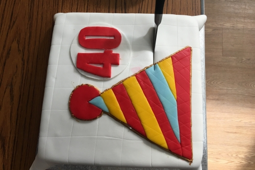 40th Birthday Cake: Square cake with white icing, decorated with a stripy red, yellow and blue icing hat and red number 40