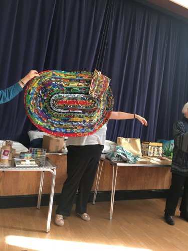 Woman holding up eliptical quilt