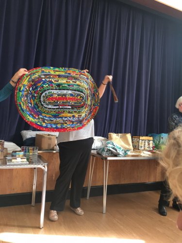 Woman holding up eliptical quilt