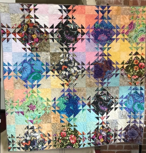 Multicoloured quilt made of diamonds and triangles