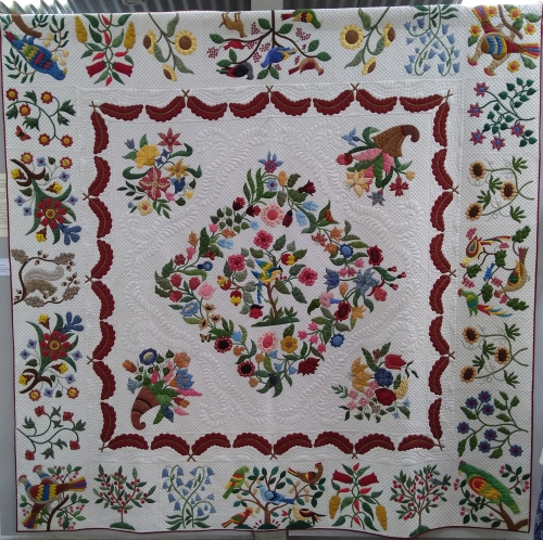 Homage to Mary Brown by Pat Cox: Beige quilt with mulitcoloured design made up of foliage and birds