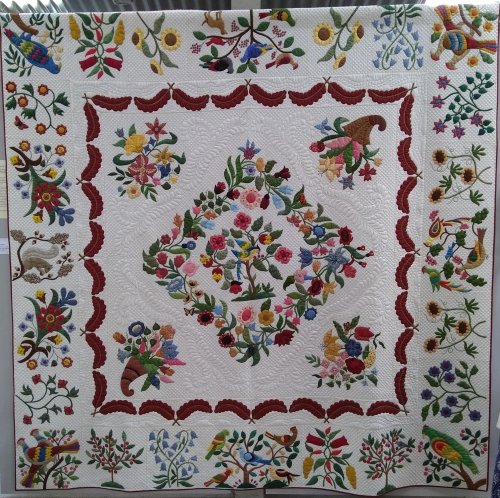 Homage to Mary Brown by Pat Cox: Beige quilt with mulitcoloured design made up of foliage and birds