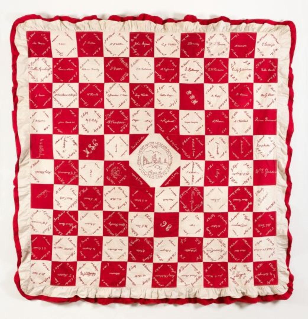Red and white squares quilt with signatures