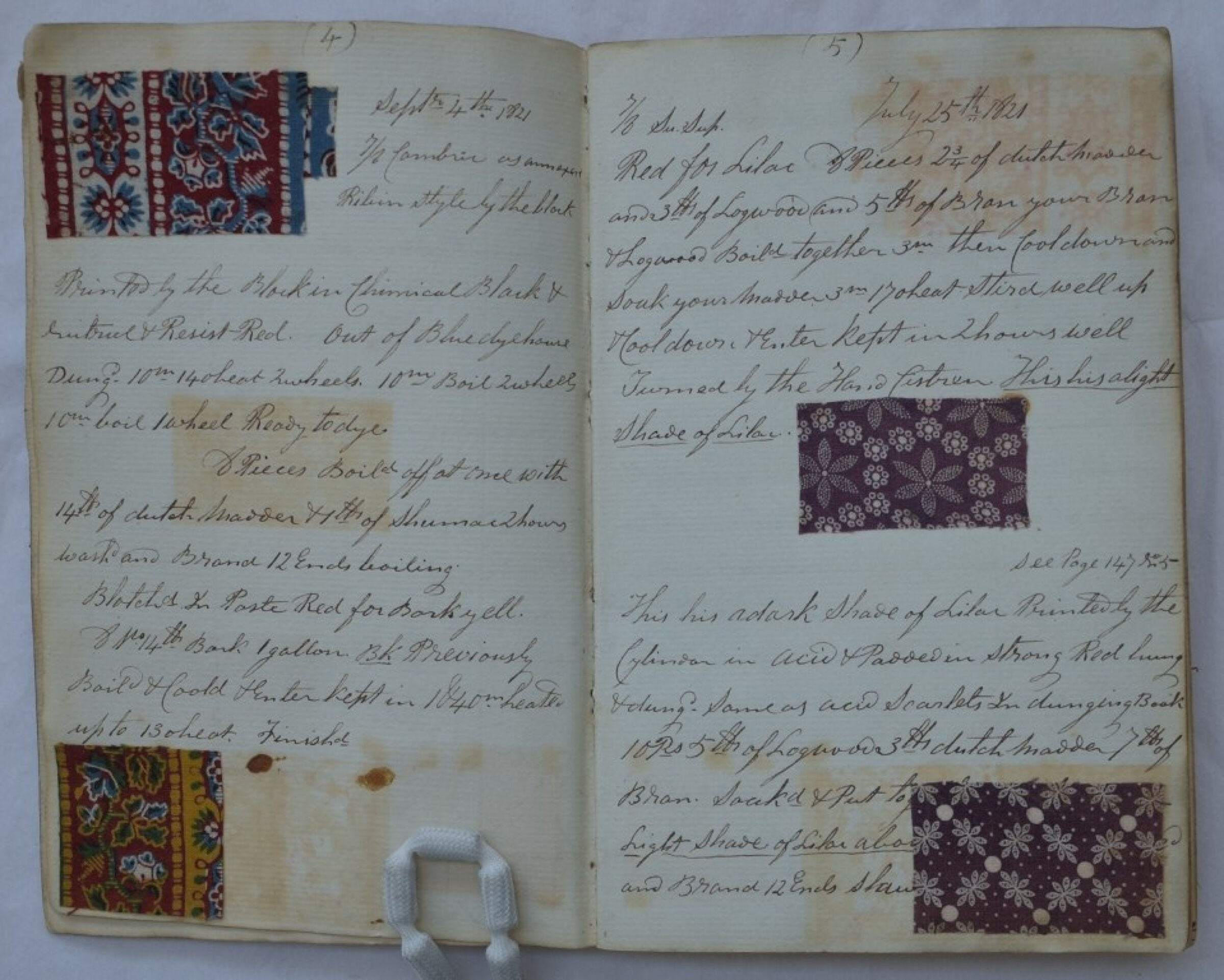Old notebook with cursive handwriting and four fabric samples