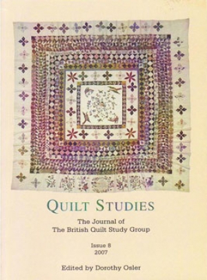 Booklet with patchwork frame quilt on white background