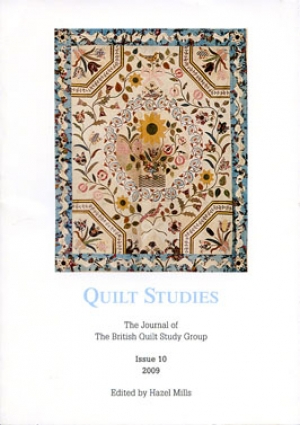 Booklet with elaborate applique quilt on white background