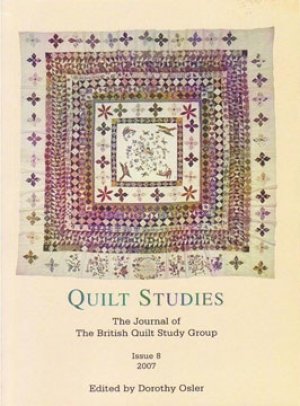 Booklet with patchwork frame quilt on white background