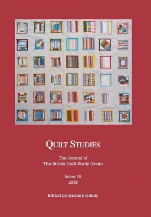 Booklet with brightly coloured patchwork on red background