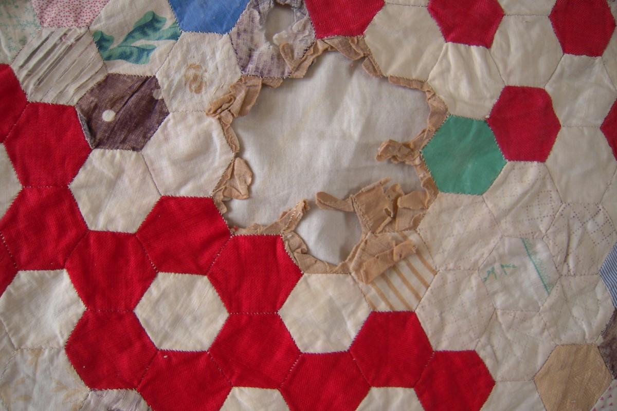 Hexagon coverlet with disintegrated fabrics