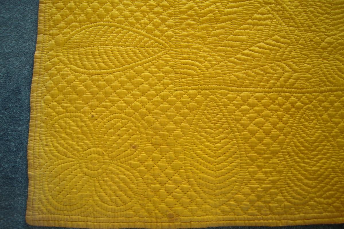 Detail of corner patterns on yellow quilt