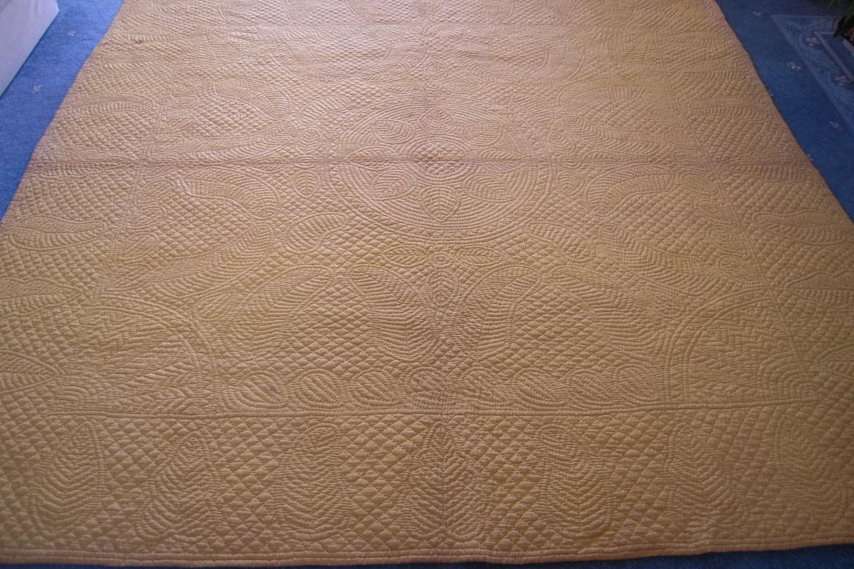 Whole yellow Quilt on floor