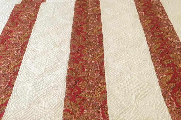 Turkey Red North Country Strippy with rows of circles quilted down cream strips