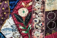 Elaborate embroidery on colourful random shapes stitched together