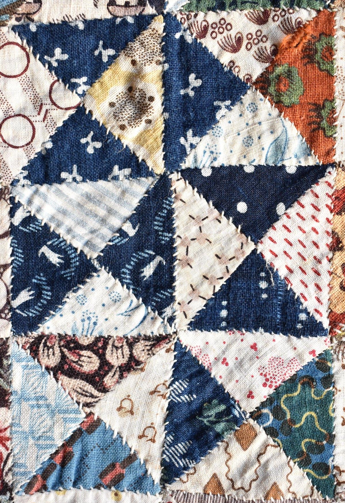 Patchwork triangles including many with blue and white designs.