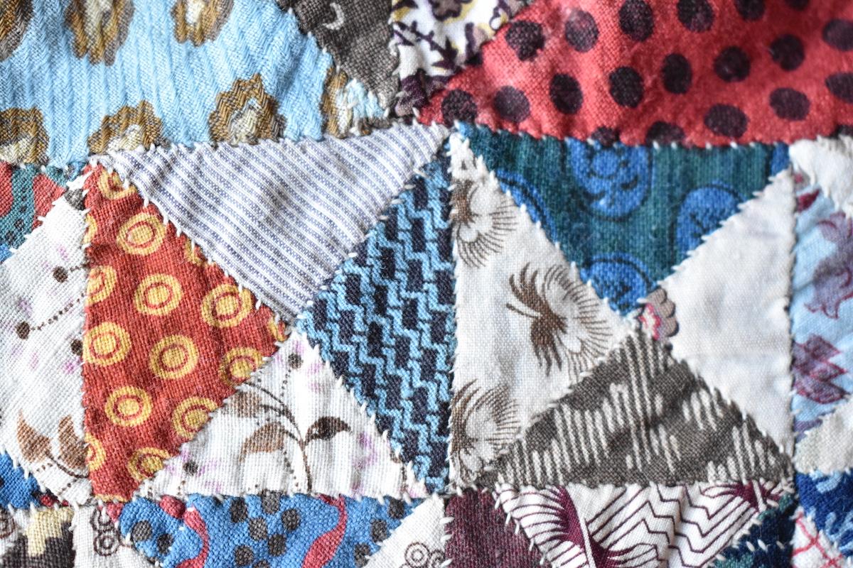 Close up showing small diagonal stitches joining fabric triangles.