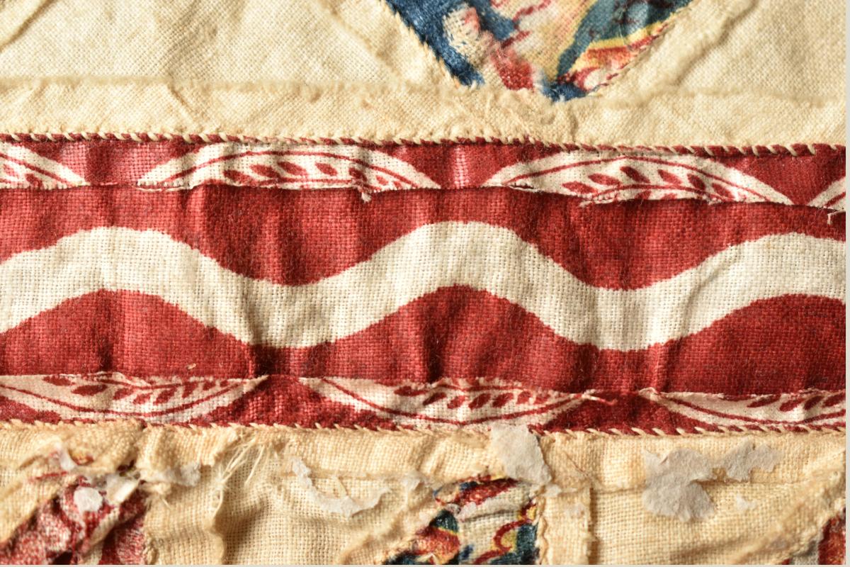 Red fabric strip with wavy white line