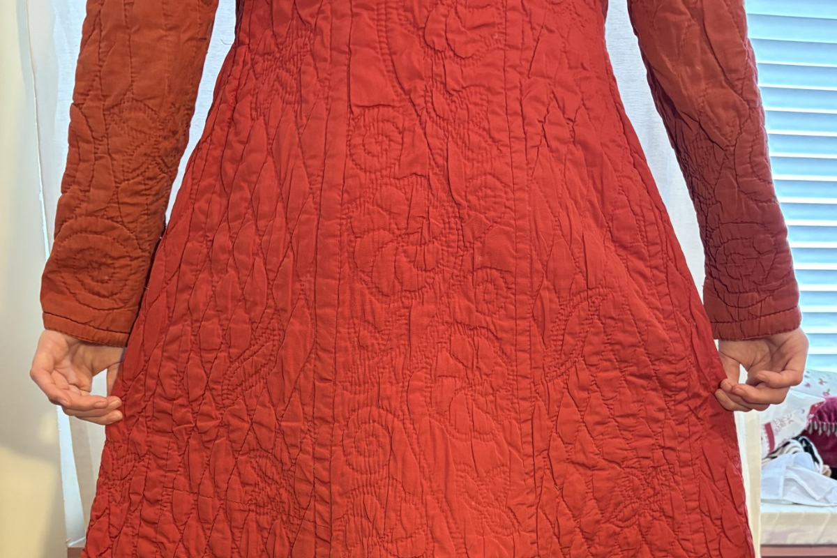 Section of hand quilted red dressing gown