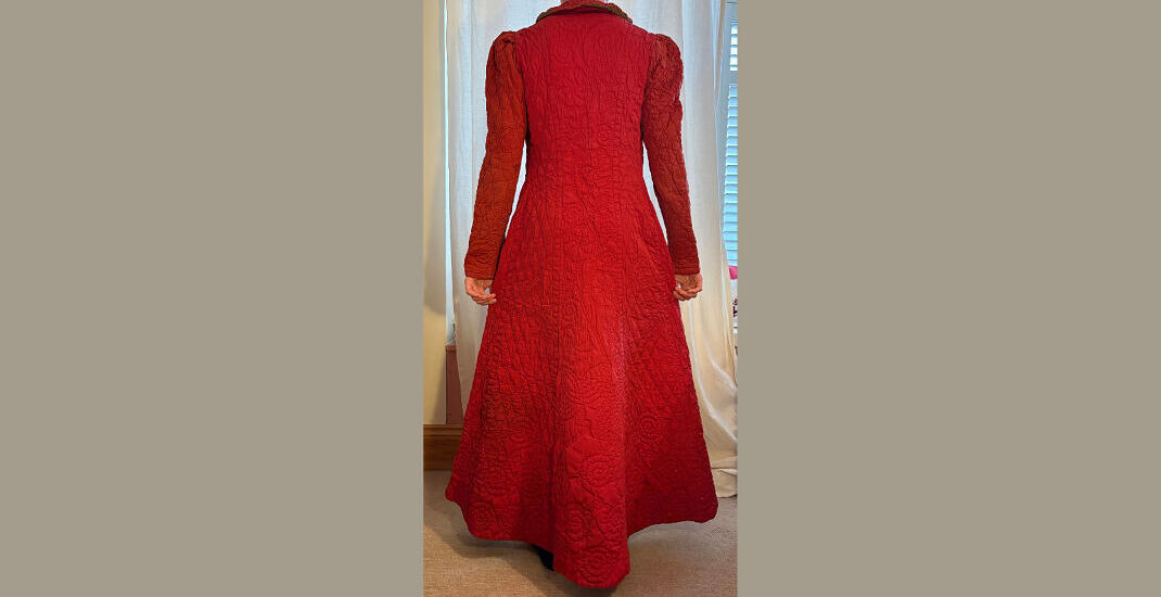 Back of hand quilted dressing gown with floral designs up centre back