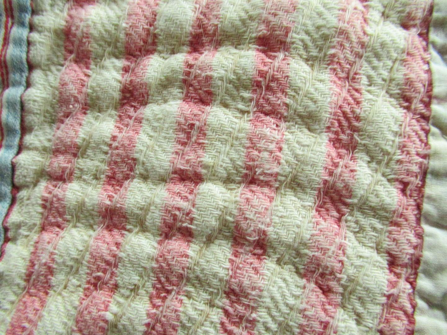 pink and white striped open-weave fabric