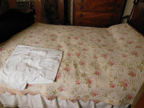 Cream floral quilt on bed