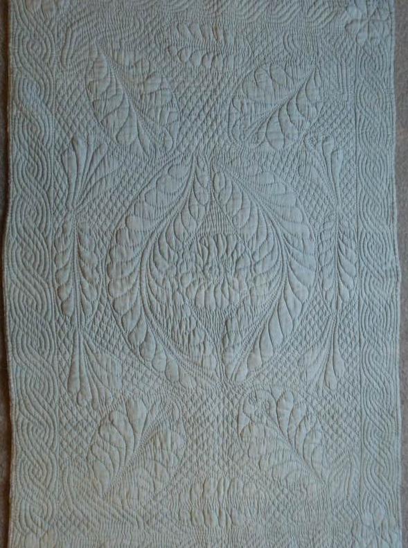 Quilted pale blue cot quilt