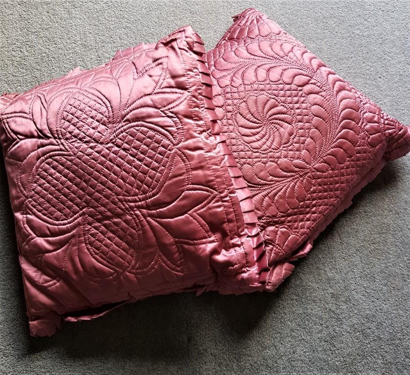 Two pink satin cushions