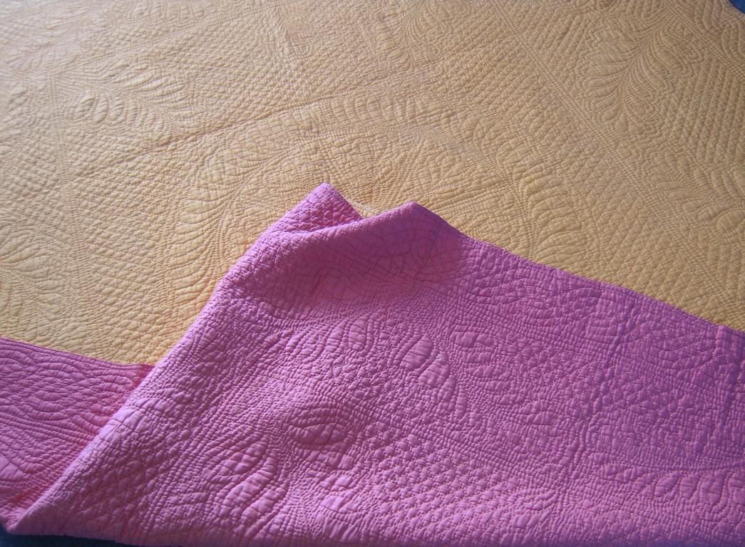 Yellow quilt with pink corner turned back