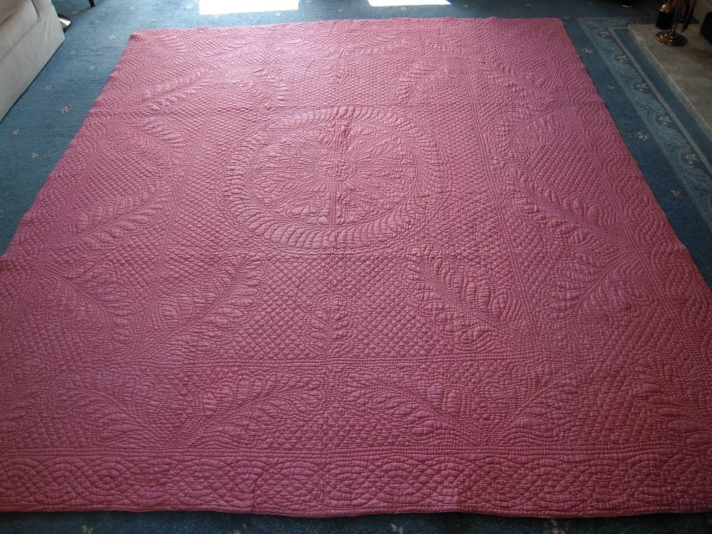 pink quilt with stitched patterns