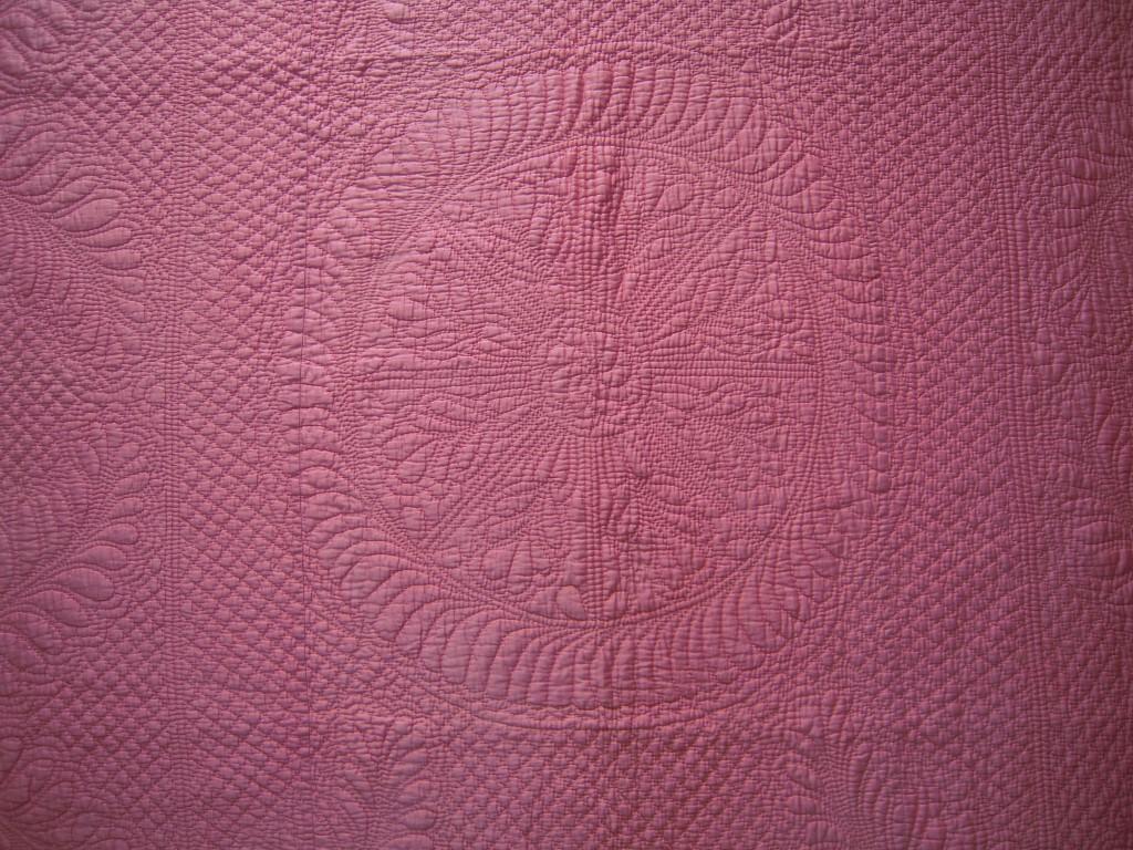 pink quilt with wheel design