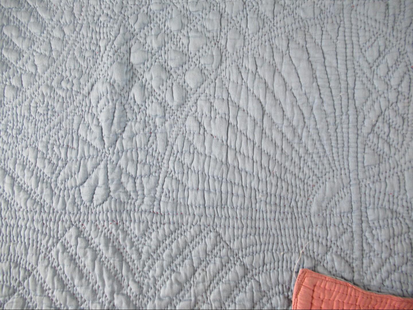 blue grey quilt with fan design