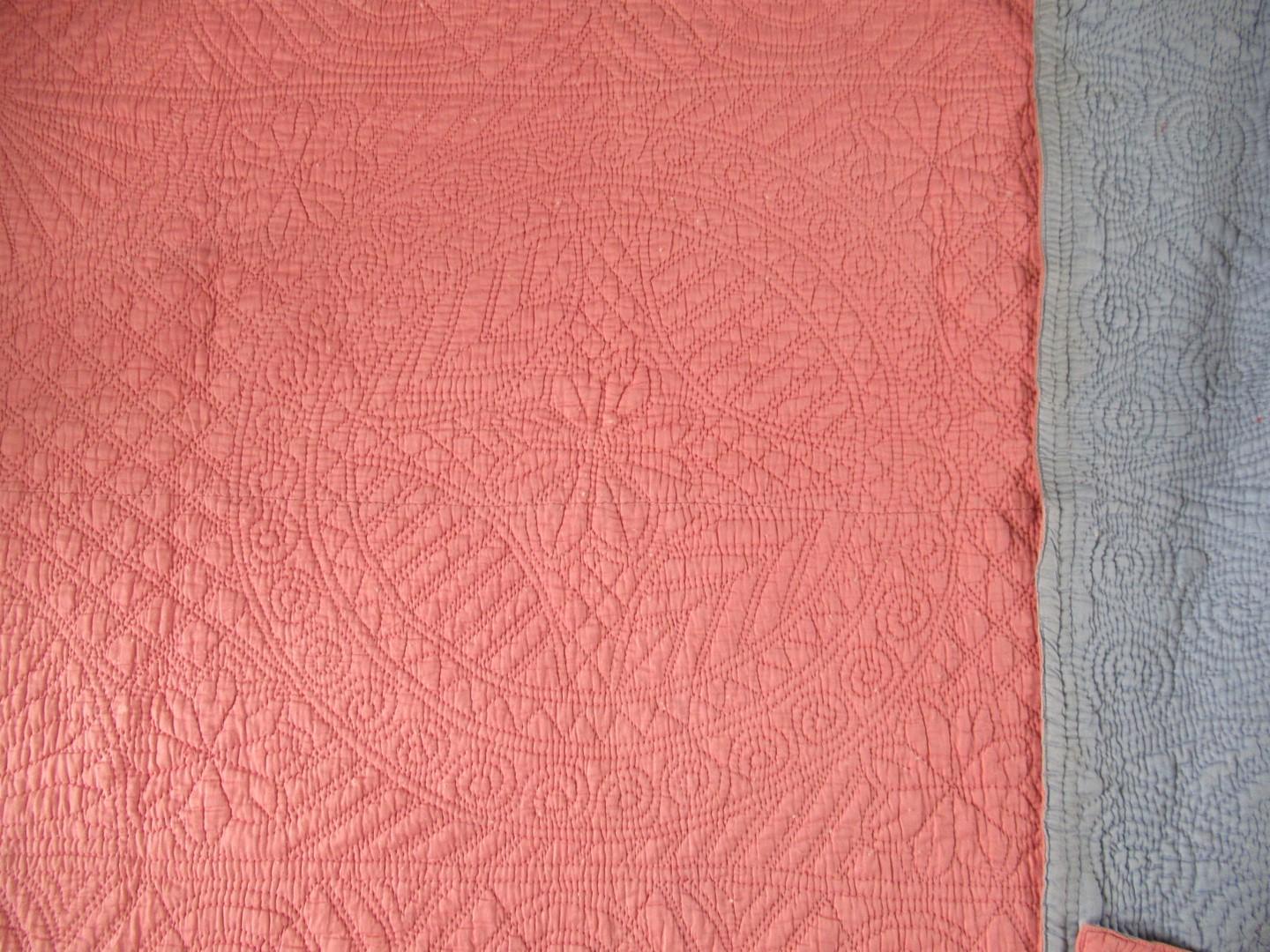 Pink quilt with a circle coin quilted design