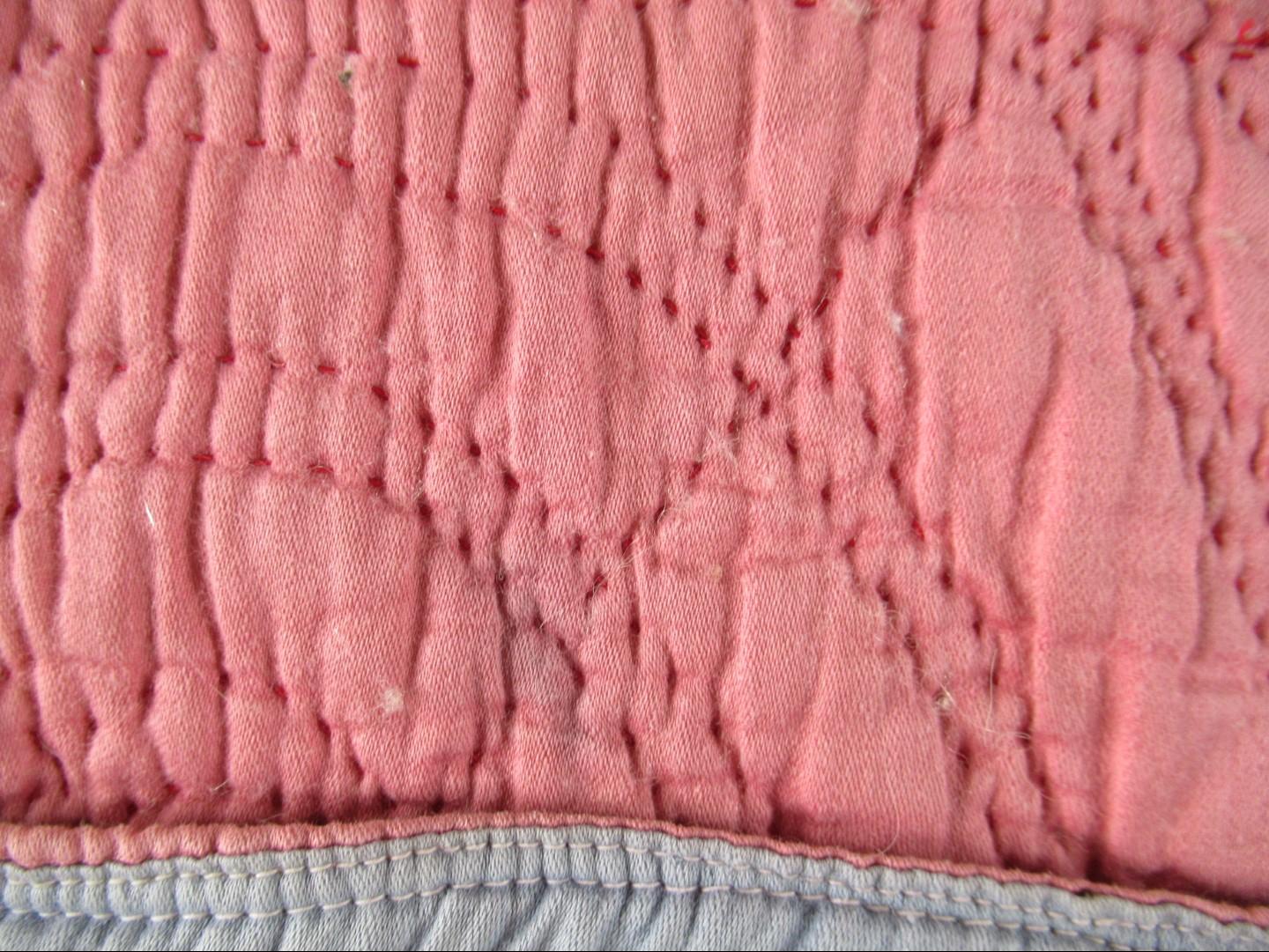 Close up of detail of pink quilt