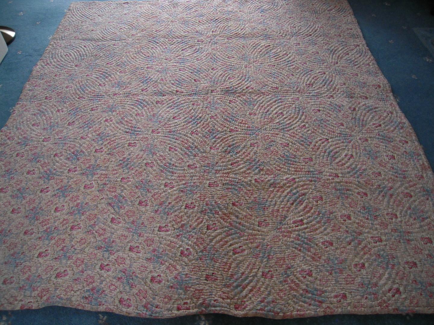 Pink, blue and cream quilt