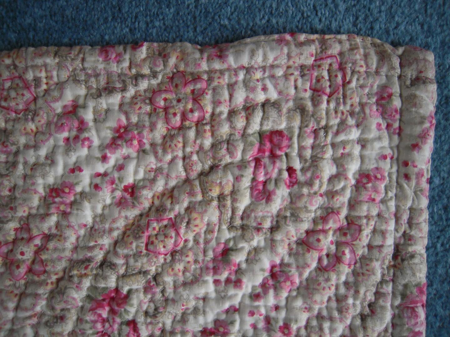 Corner of pink and cream floral quilt