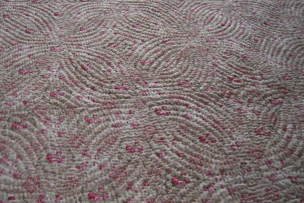 Pink and cream floral quilt section with quilting