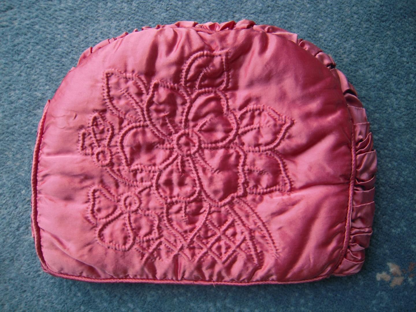 Pink tea cosy with stitched flowers