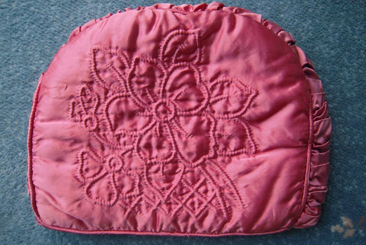Pink tea cosy with stitched flowers