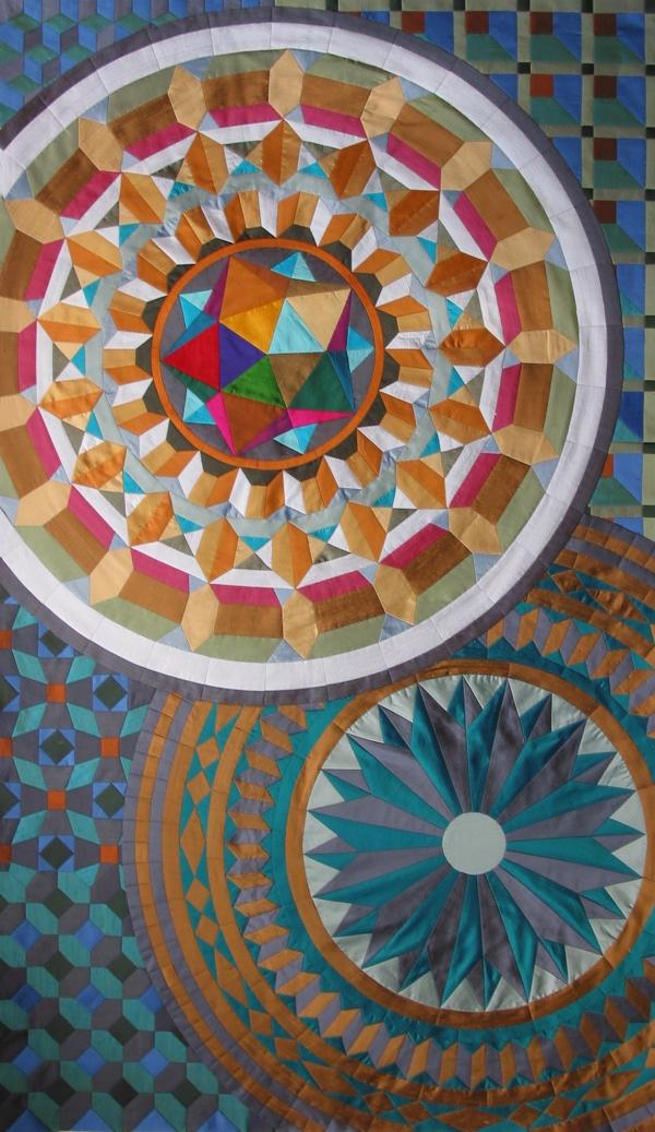 Multi coloured image of quilt with two large mosaic circles