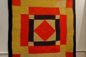 Detail of orange, yellow and black geometric quilt