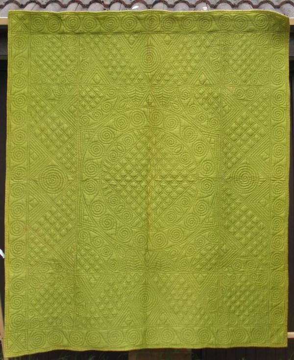Yellow quilt with stitched patterns