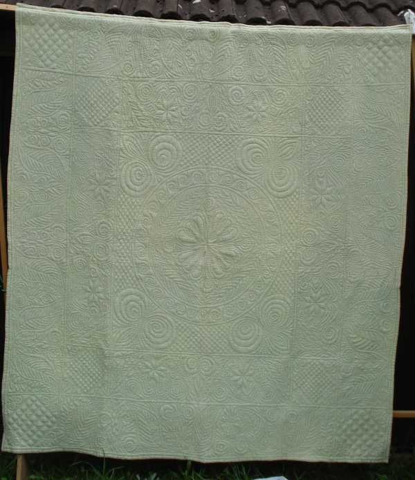 Cream quilt with stitched patterns