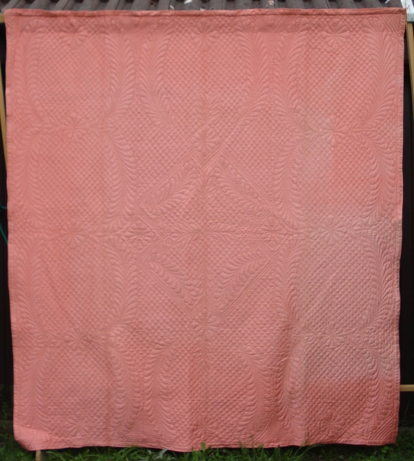 Pink quilt with patterned stitching
