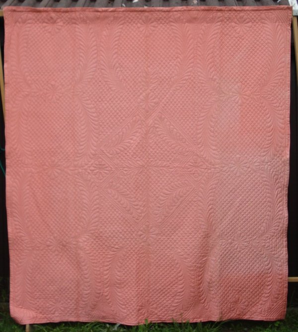 Pink quilt with patterned stitching