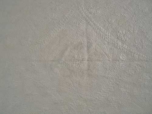 white quilt with detailed stitching