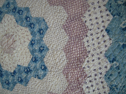 White blue and pink heaxagon quilt detail