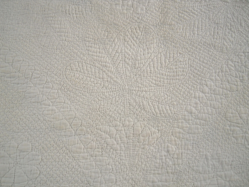 White quilt with detailed stitching