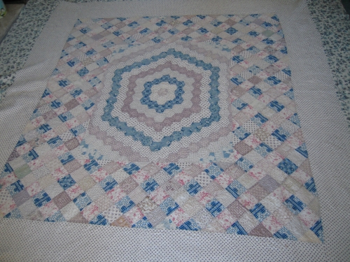Pink white and blue patchwork quilt