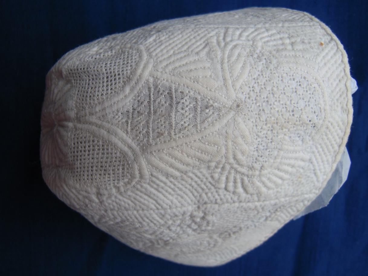 Detail of stitching on white bonnet