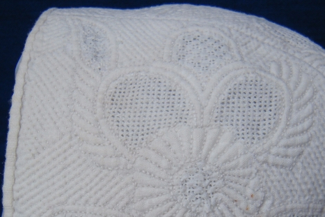 White stitching detail of baby's bonnet