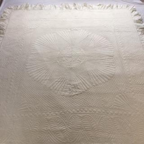 Cream quilt with stitched patterns